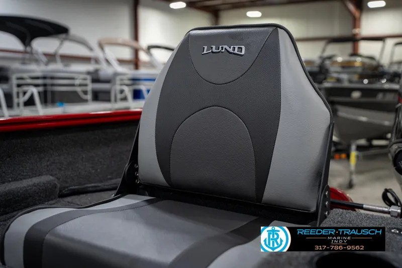 Slide: The Image of 2026 Lund 1650 Rebel XL SS boat seat in showroom, featuring sleek design and logo. - 40