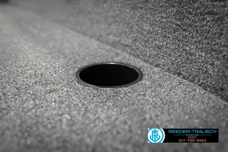 Slide: The Image of 2026 Lund 1650 Rebel XL SS boat interior with carpeted surface and cup holder. - 41