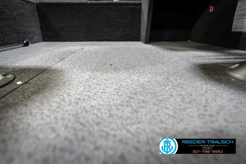Slide: The Image of 2026 Lund 1650 Rebel XL SS boat interior with carpeted flooring, showcased by Reeder Trausch Marine. - 43