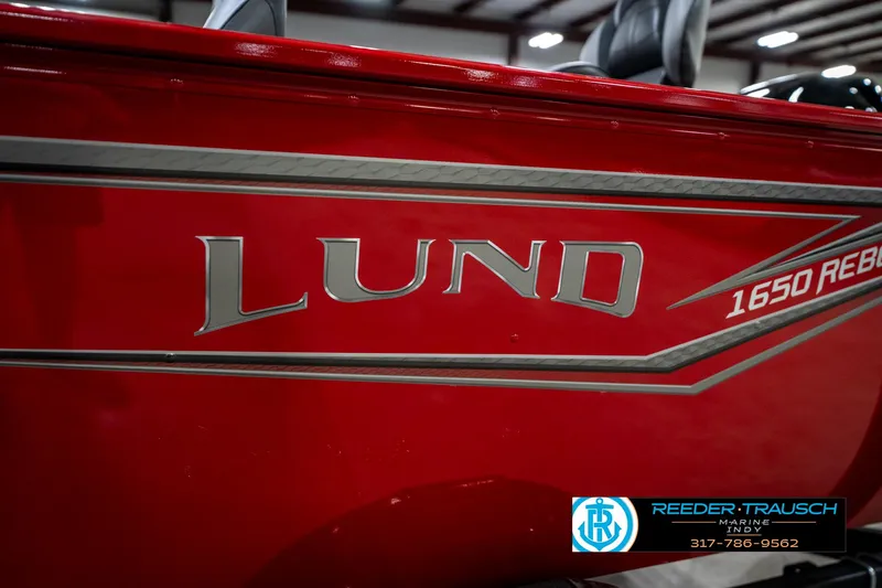 Slide: The Image of Red 2026 Lund 1650 Rebel XL SS boat with logo and dealership contact information. - 48