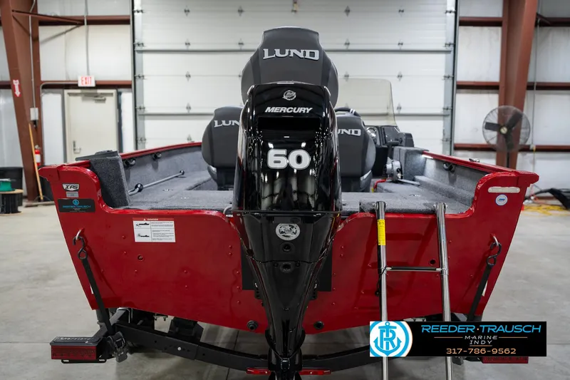 Slide: The Image of 2026 Lund 1650 Rebel XL SS boat with Mercury 60 engine in a garage setting. - 7