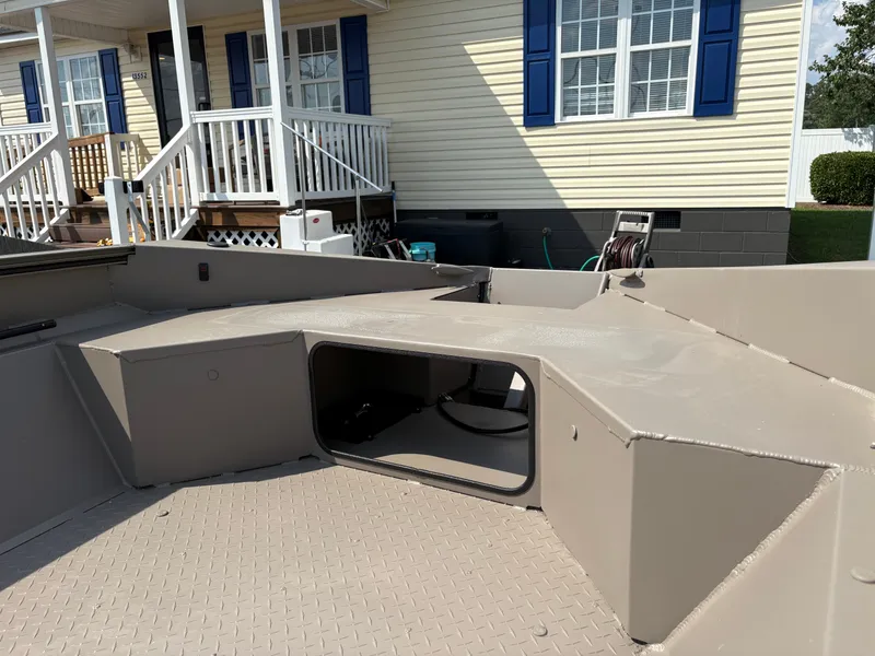 Slide: The Image of 2025 Edge Duck Boats 656DB Sportsman, beige interior, near a house with blue shutters. - 3