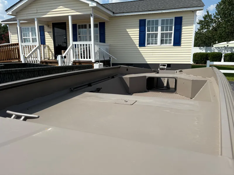 Slide: The Image of 2025 Edge Duck Boats 656DB Sportsman parked in front of a yellow house with blue shutters. - 4