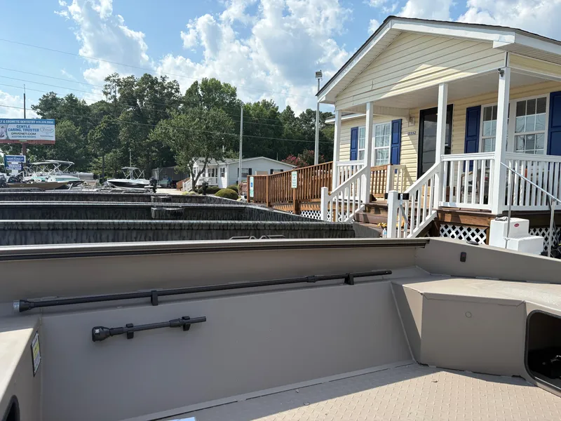 Slide: The Image of 2025 Edge Duck Boats 656DB Sportsman near a house with a porch and trees. - 5