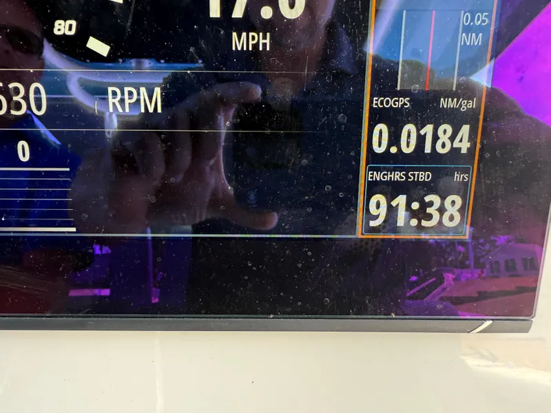 Slide: The Image of Display panel of 2024 Boston Whaler 330 Outrage showing speed, RPM, and engine hours. - 13