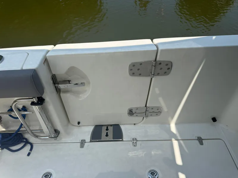 Slide: The Image of 2024 Boston Whaler 330 Outrage boat deck with stainless steel fittings and water view. - 18