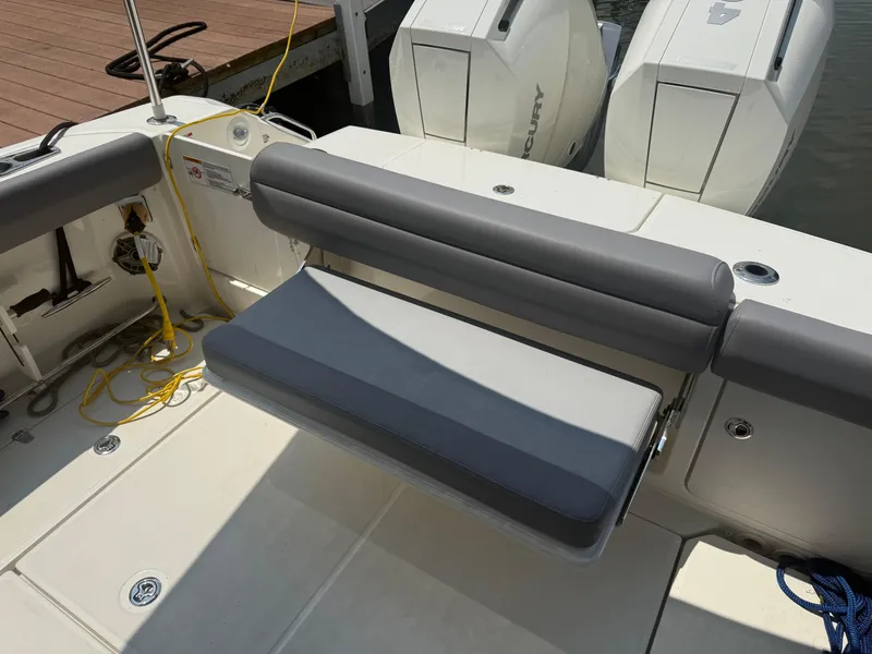 Slide: The Image of 2024 Boston Whaler 330 Outrage boat with dual Mercury engines and cushioned seating. - 25