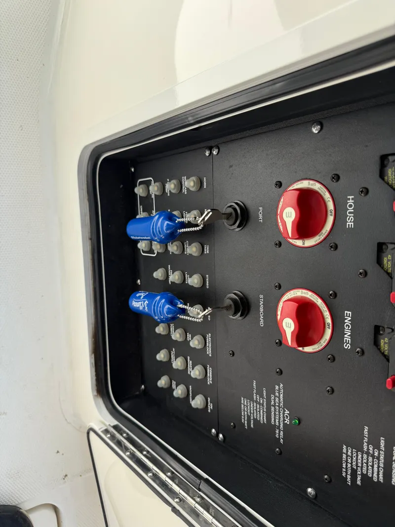 Slide: The Image of Control panel of 2024 Boston Whaler 330 Outrage boat with switches and dials. - 26
