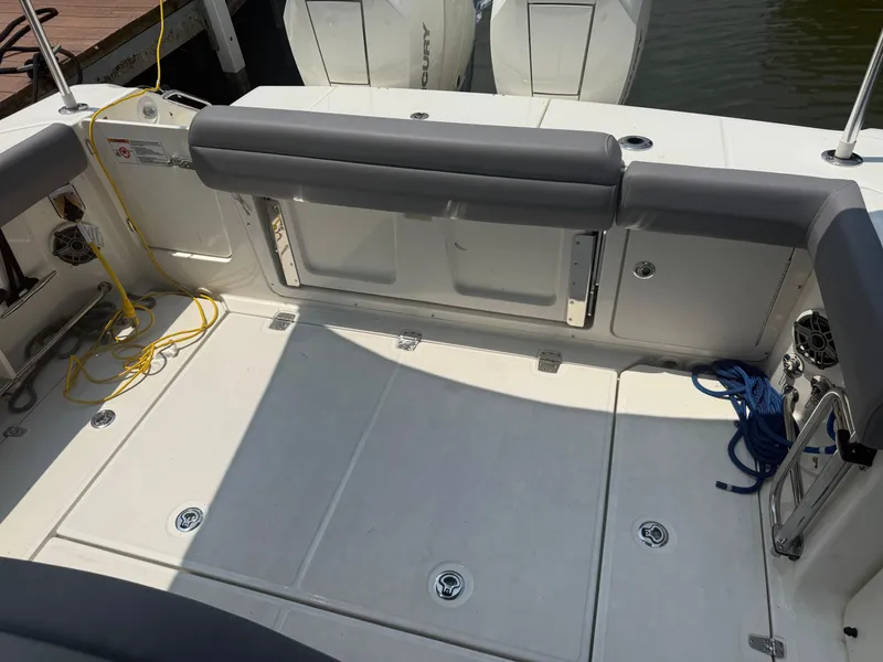 Slide: The Image of 2024 Boston Whaler 330 Outrage boat deck with seating and storage compartments. - 27