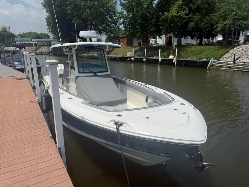 Slide: The Image of 2024 Boston Whaler 330 Outrage docked on a sunny day. - 8
