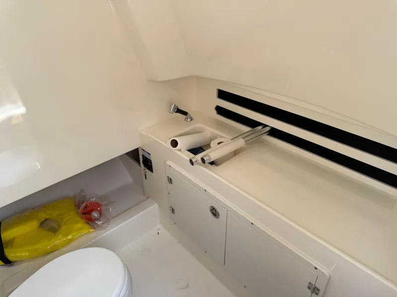 Slide: The Image of 2024 Boston Whaler 330 Outrage interior with sink, storage, and life jacket. - 9