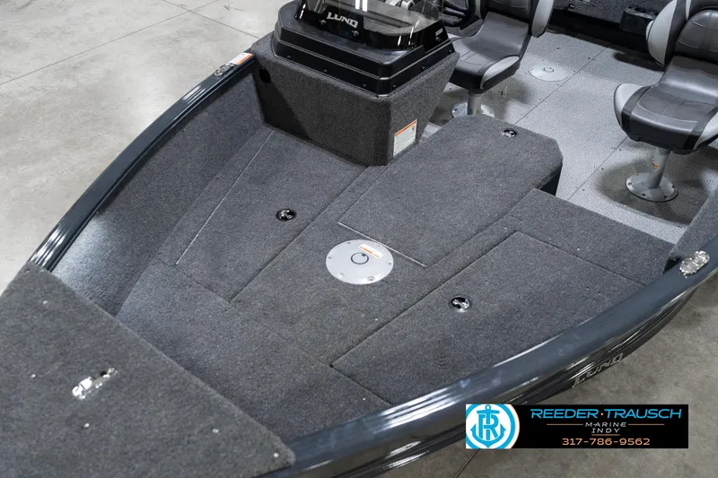 Slide: The Image of 2026 Lund 1775 Adventure SS boat interior with gray carpet and seating. - 11