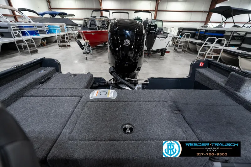 Slide: The Image of 2026 Lund 1775 Adventure SS boat interior with motor, displayed in showroom. - 16