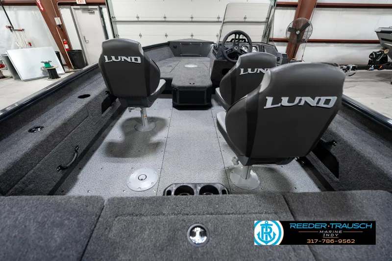 Slide: The Image of 2026 Lund 1775 Adventure SS boat interior with branded seats in a showroom. - 17