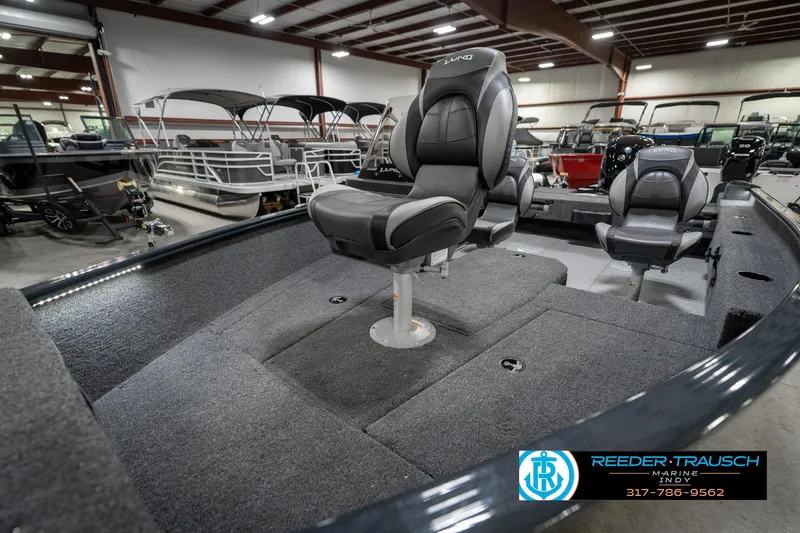 Slide: The Image of 2026 Lund 1775 Adventure SS boat interior with seating, displayed in a showroom. - 20