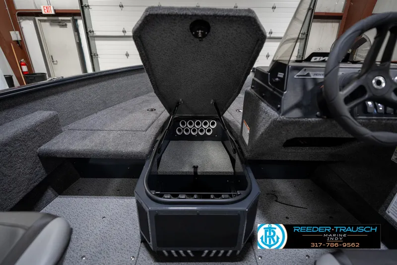 Slide: The Image of 2026 Lund 1775 Adventure SS boat interior with open storage compartment and steering wheel. - 24