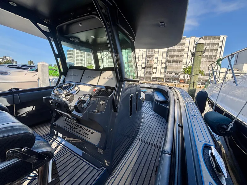 Slide: The Image of 2016 Hydra-Sports 4200 Siesta boat interior with Garmin navigation, docked in a marina. - 19