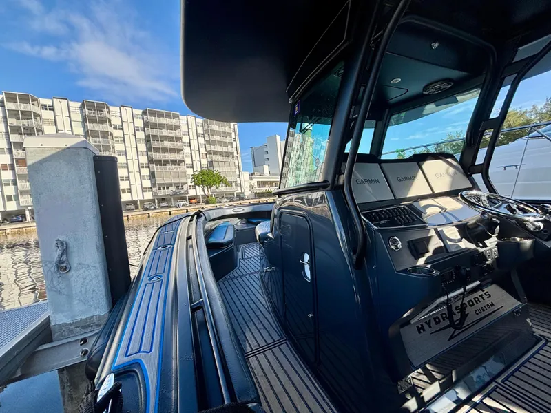 Slide: The Image of 2016 Hydra-Sports 4200 Siesta boat docked, featuring sleek design and modern controls. - 20