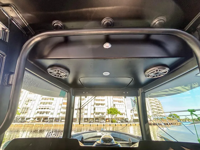 Slide: The Image of Interior view of 2016 Hydra-Sports 4200 Siesta boat with speakers and cityscape background. - 34