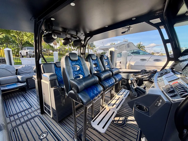 Slide: The Image of 2016 Hydra-Sports 4200 Siesta boat interior with blue and black seating, docked at marina. - 36