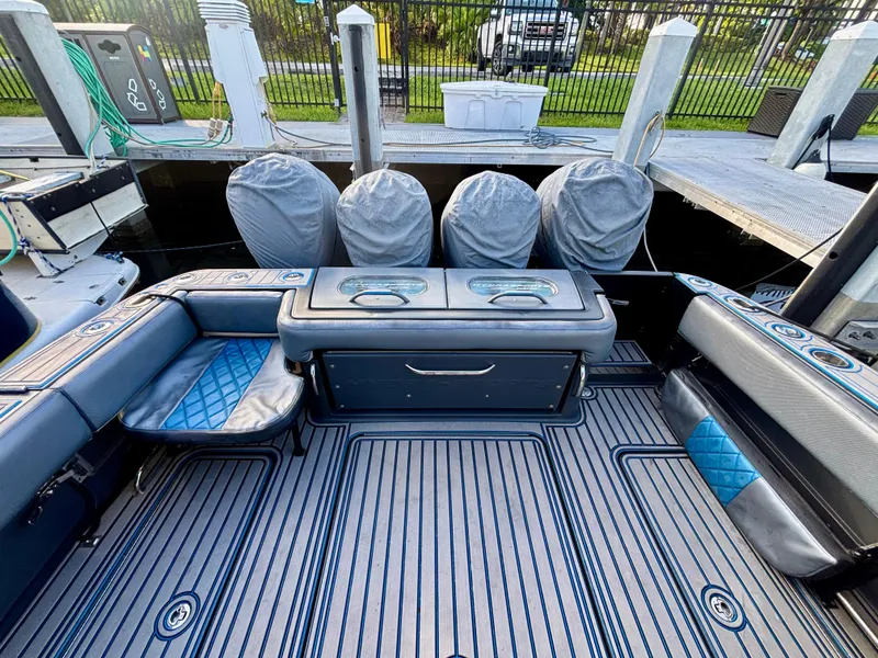 Slide: The Image of 2016 Hydra-Sports 4200 Siesta boat interior with seating and covered engines at dock. - 49