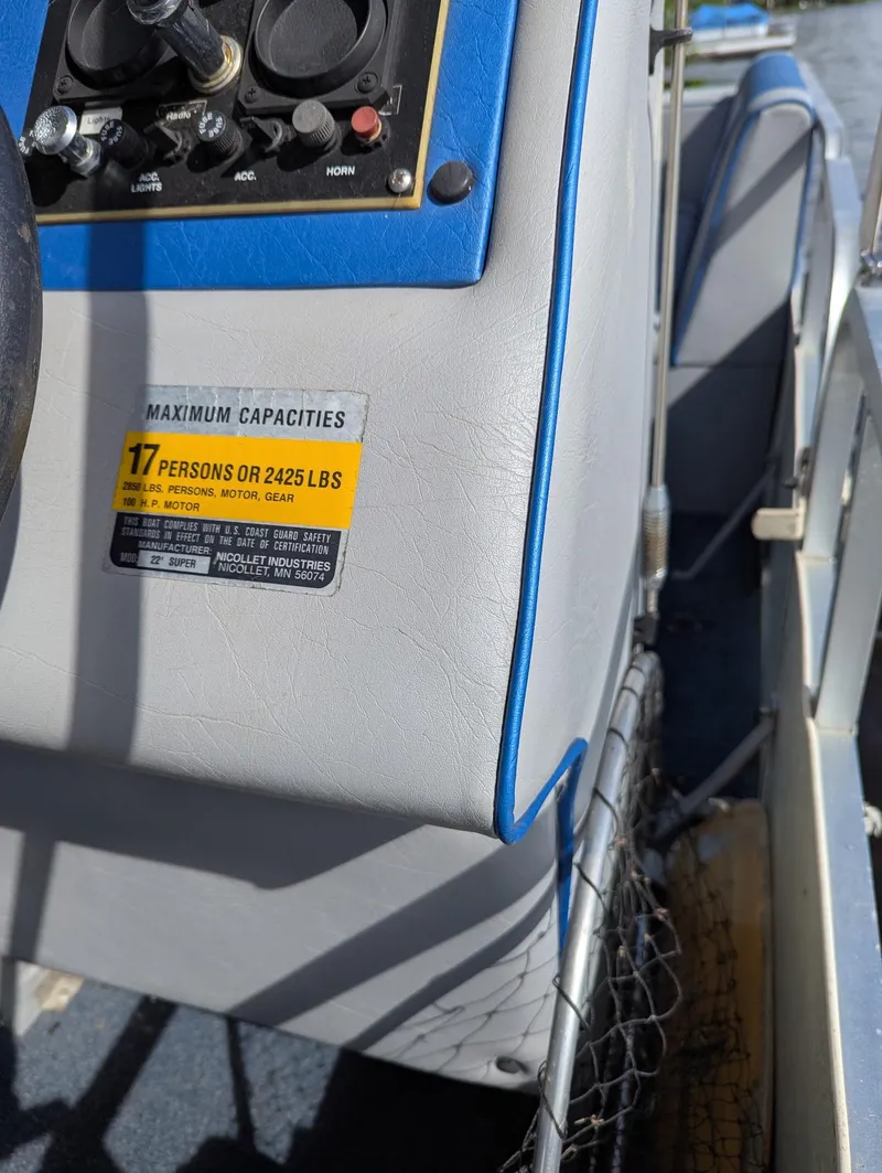 Slide: The Image of Control panel of a 1991 Palm Beach Super 220 boat with capacity label. - 10