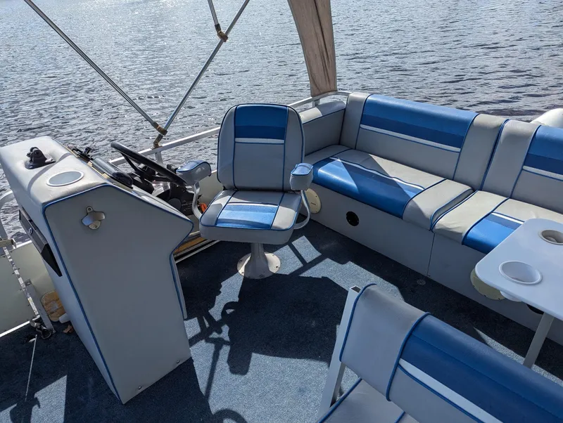 Slide: The Image of Interior of a 1991 Palm Beach Super 220 boat with blue and white seating. - 12