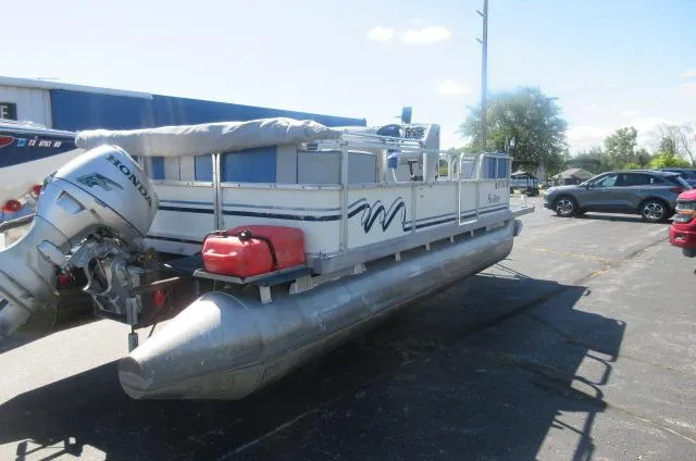 Slide: The Image of 1991 Palm Beach Super 220 pontoon boat with Honda outboard motor in a parking lot. - 16
