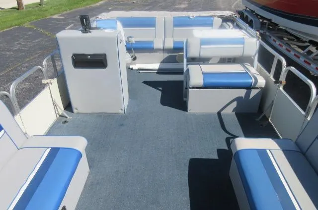 Slide: The Image of 1991 Palm Beach Super 220 boat interior with blue and white seating. - 18