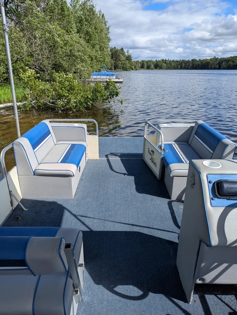 Slide: The Image of Pontoon boat "Palm Beach Super 220" on a serene lake, 1991 model. - 2