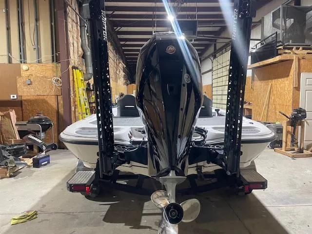 Slide: The Image of 2023 Falcon Boats F205 in a garage, rear view with motor and propeller visible. - 3