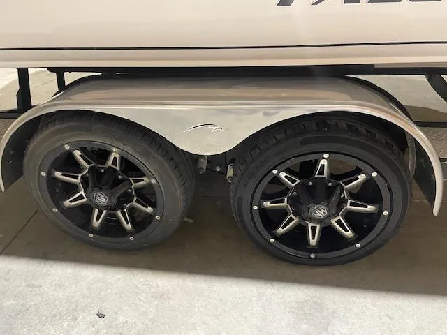 Slide: The Image of 2023 Falcon Boats F205 trailer with dual black alloy wheels. - 7