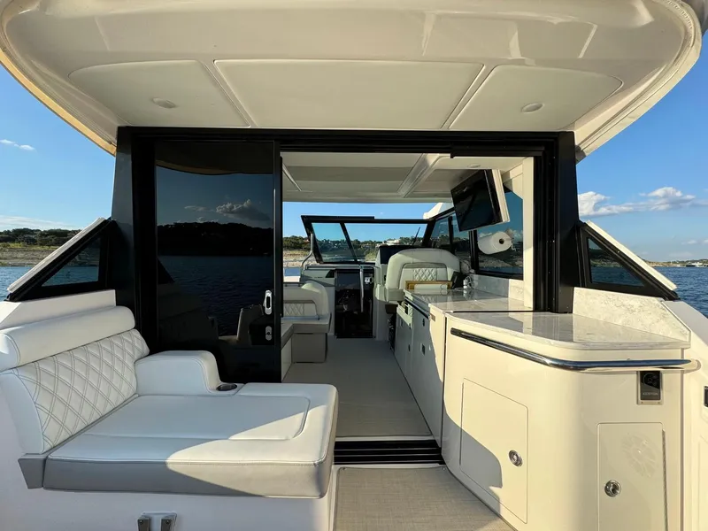 Slide: The Image of 2021 Regal 36 Grande Coupe yacht interior with luxurious seating and modern amenities. - 19