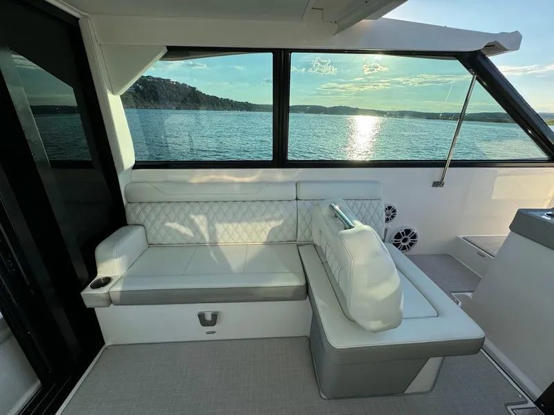 Slide: The Image of Interior of 2021 Regal 36 Grande Coupe with lake view through large windows. - 23