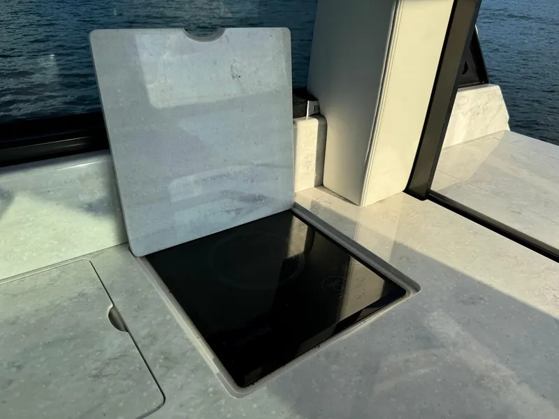 Slide: The Image of 2021 Regal 36 Grande Coupe yacht kitchen with sleek countertop and stove. - 26