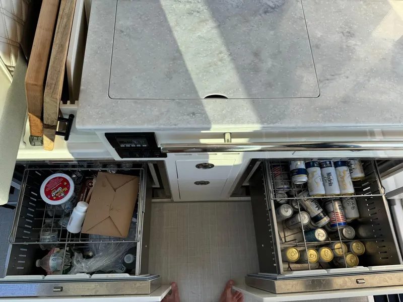 Slide: The Image of Kitchen area of 2021 Regal 36 Grande Coupe with open drawers and beverages. - 27