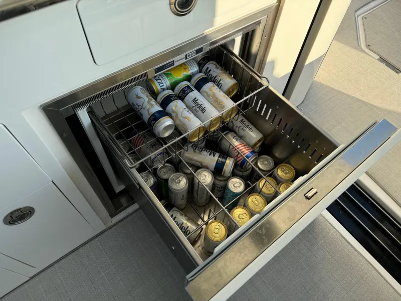 Slide: The Image of Drawer fridge on 2021 Regal 36 Grande Coupe, stocked with assorted beverage cans. - 28