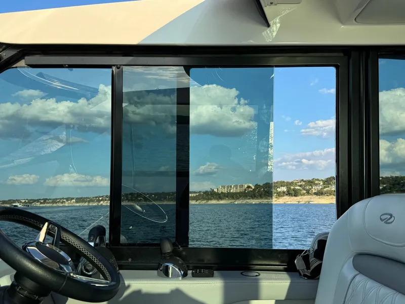 Slide: The Image of Interior view of 2021 Regal 36 Grande Coupe yacht with ocean and coastline through window. - 30