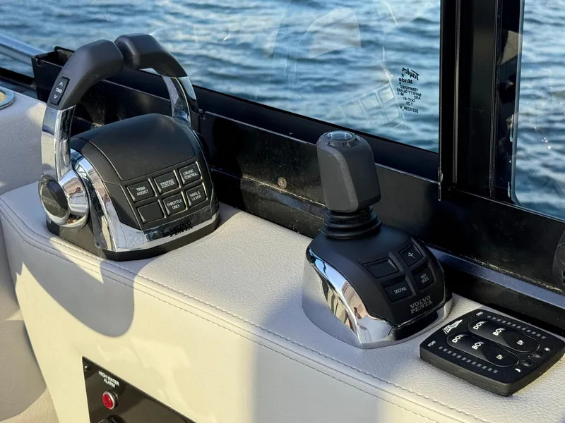 Slide: The Image of Control panel of 2021 Regal 36 Grande Coupe boat with throttle and joystick. - 32