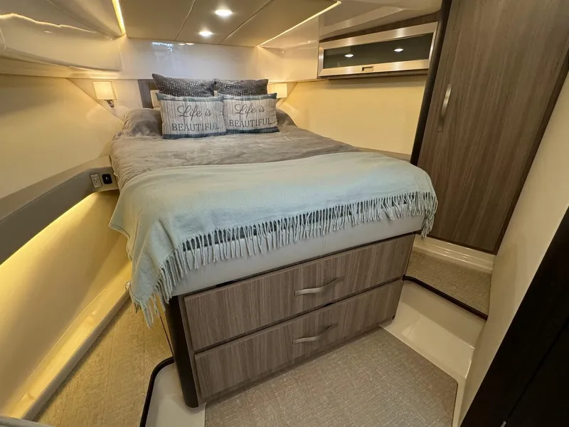 Slide: The Image of Luxurious bedroom interior of 2021 Regal 36 Grande Coupe yacht with cozy bedding. - 4
