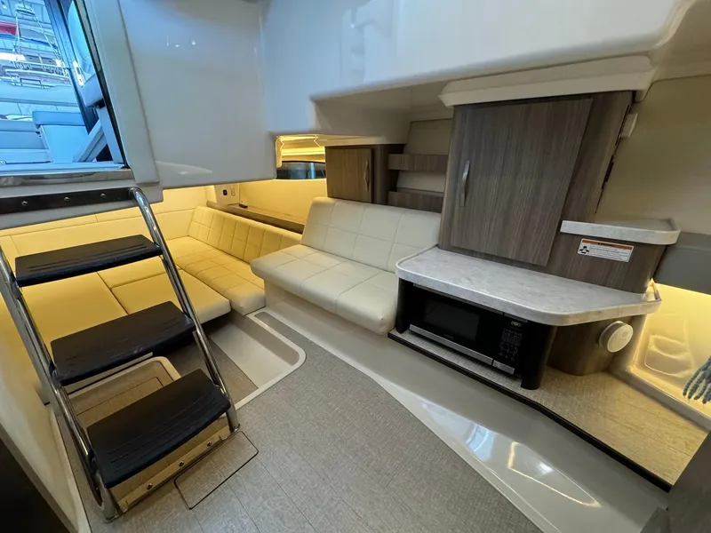 Slide: The Image of Luxurious interior of 2021 Regal 36 Grande Coupe yacht with modern seating and kitchenette. - 40