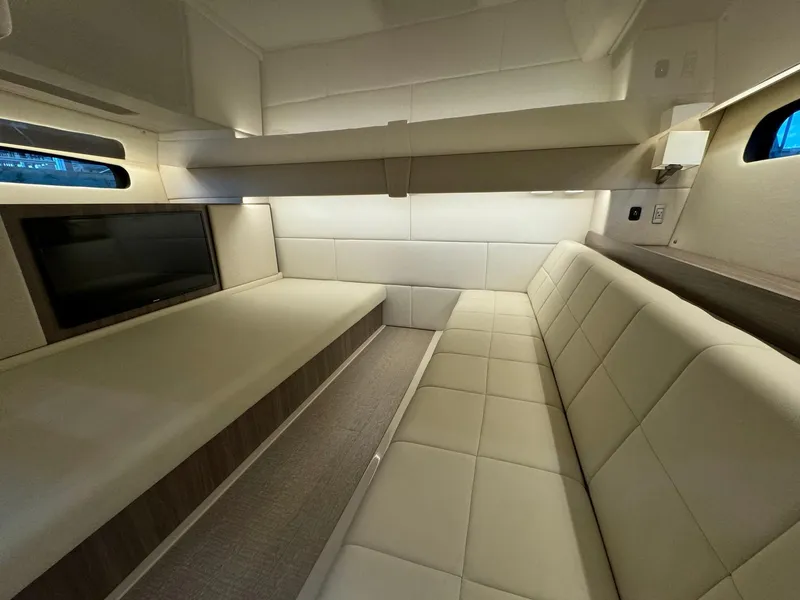 Slide: The Image of 2021 Regal 36 Grande Coupe interior with beige seating and wall-mounted TV. - 5