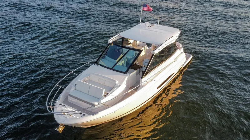 Slide: The Image of 2021 Regal 36 Grande Coupe yacht cruising on open water. - 7