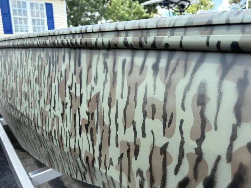 Slide: The Image of 2025 Edge Duck Boats Standard 656DB in a showroom, featuring a camouflage design. - 3