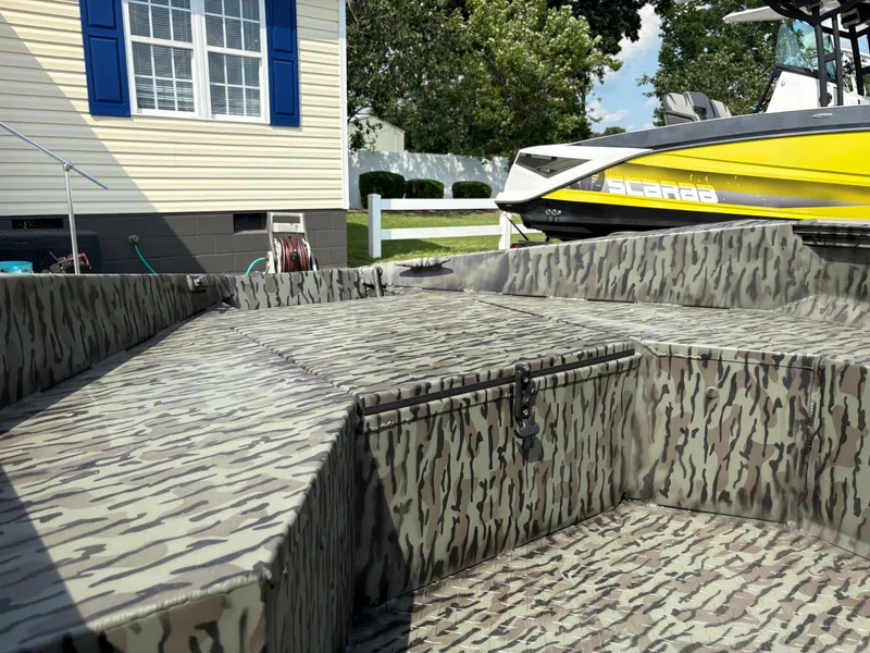 Slide: The Image of 2025 Edge Duck Boats Standard 656DB with Suzuki outboard motor, parked on a trailer. - 4