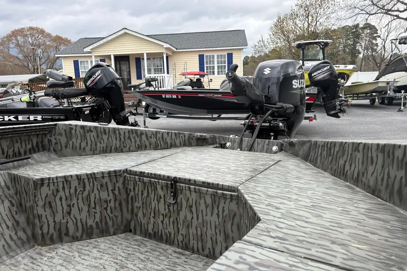 Slide: The Image of 2025 Edge Duck Boats Standard 656DB with camo design, featuring Suzuki and Mercury outboard motors. - 9