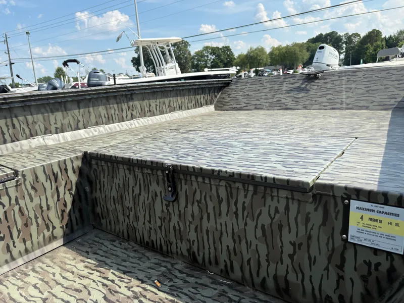 Slide: The Image of 2025 Edge Duck Boats Standard 656DB with camouflage design, showcasing seating and storage area. - 5