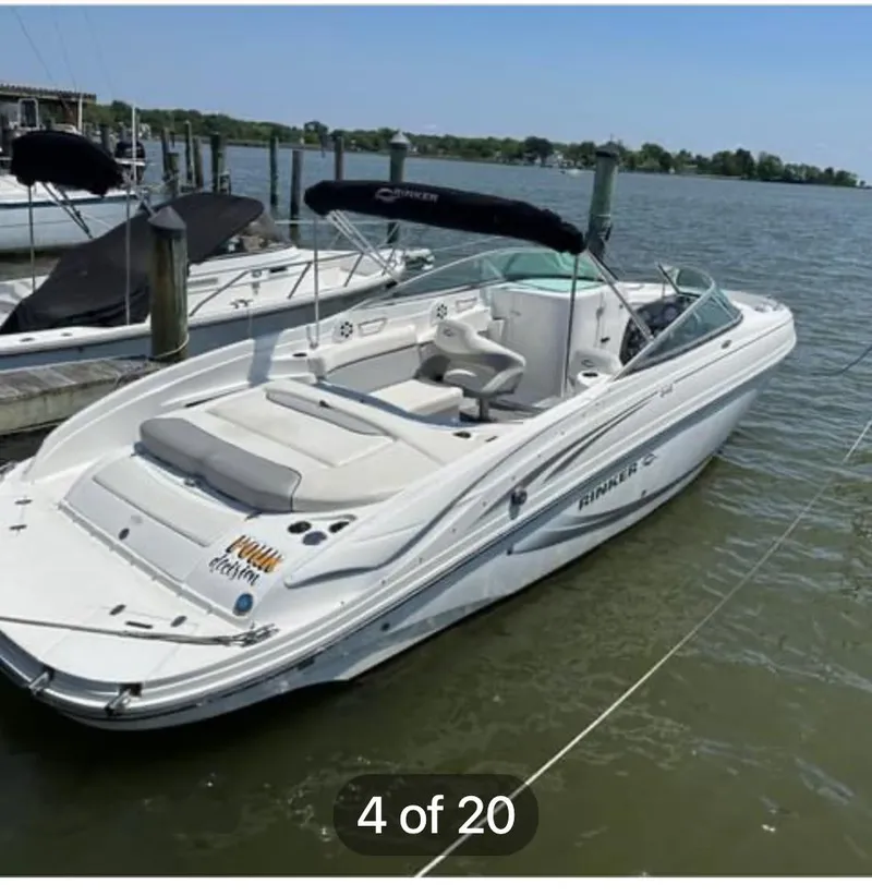The Image of 2015 Rinker 246 Captiva Bowrider docked on calm water. - 1