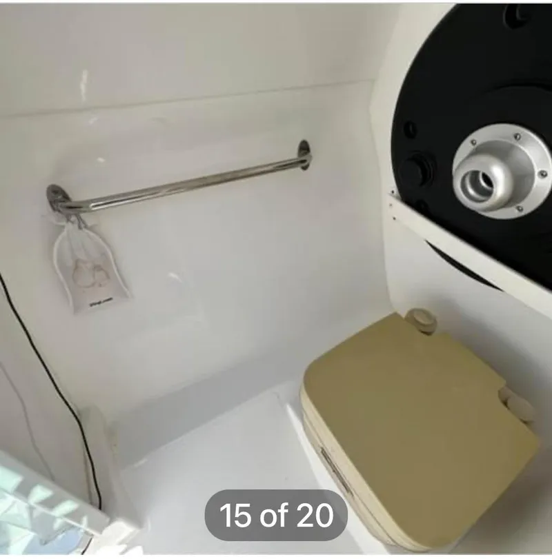 Slide: The Image of 2015 Rinker 246 Captiva Bowrider interior with portable toilet and grab rail. - 10