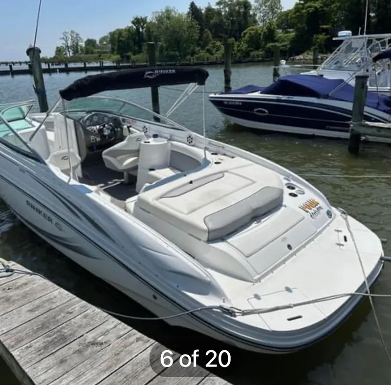 Slide: The Image of 2015 Rinker 246 Captiva Bowrider docked at a marina, sunny day. - 3